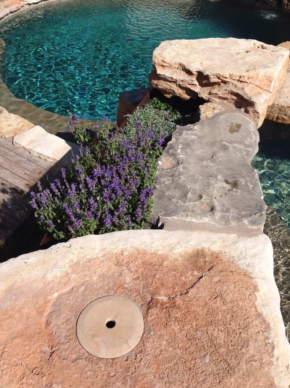 StoneLids composite stone skimmer cover blending into a modern pool deck