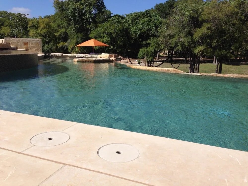 StoneLids composite stone cover installed on a custom pool