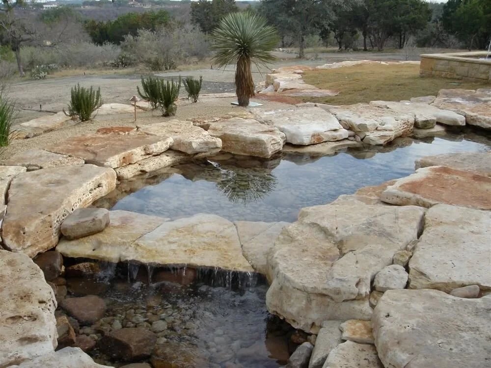 Bunkhouse Creek custom pool by Modern Pools in Hill Country