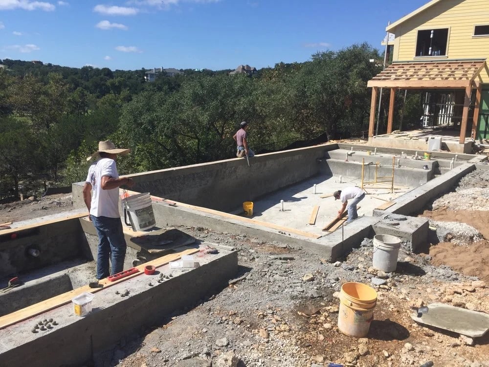 Modern Pools crew building a steel reinforced gunite pool shell on an Austin Hill Country lot