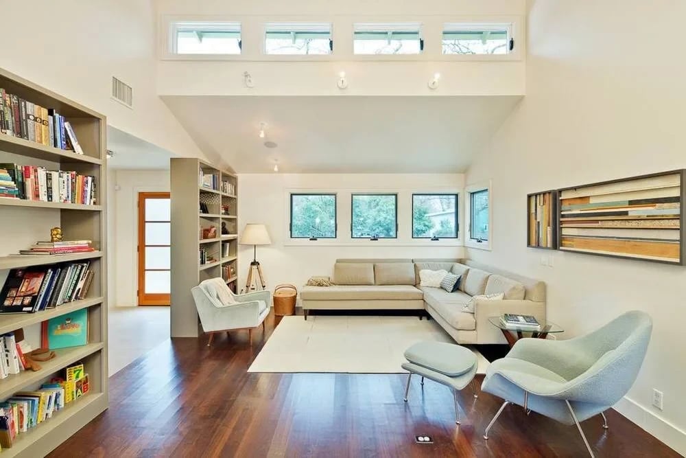 Bright living room with a sectional sofa, built-in bookshelves and clerestory windows