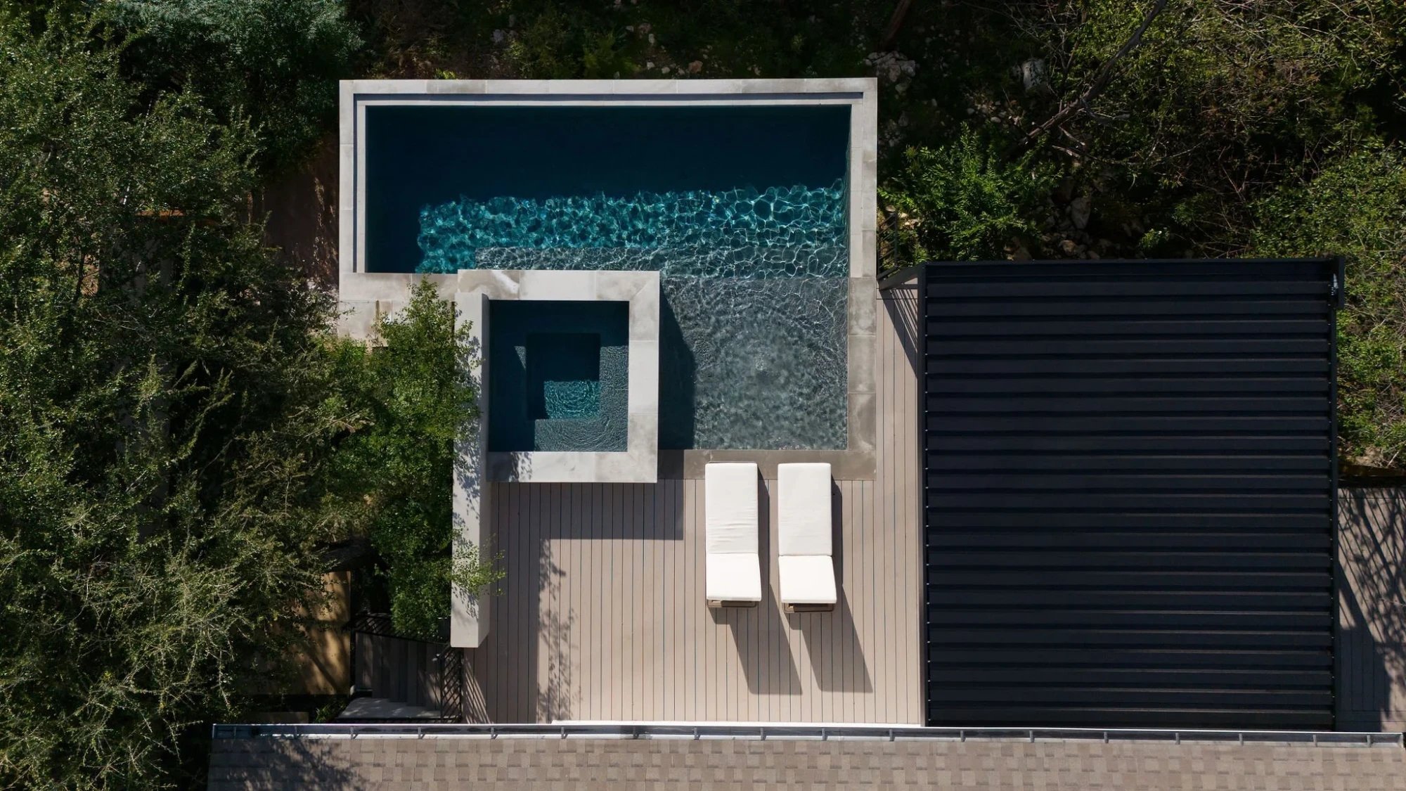 Aerial view of a modern geometric pool, spa, and sun deck in Austin restored after alkali-silica reaction damage
